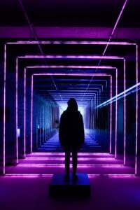 silhouette-photo-of-person-standing-in-neon-lit-hallway